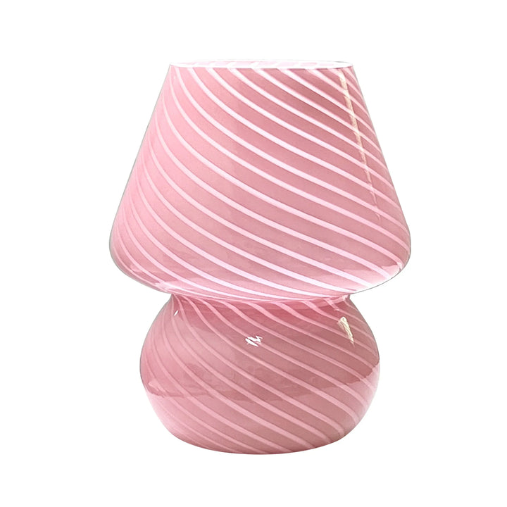 Stripe patterned glass table lamp viewed from a side angle to showcase its silhouette