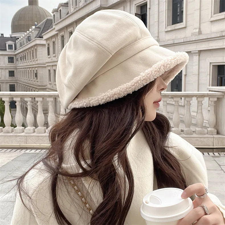Side view of a woman wearing the beige winter bucket hat outdoors