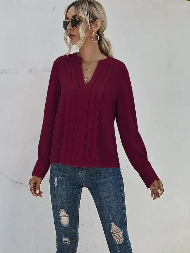 Close-up view of the fine pleating detail on the stylish casual chic top