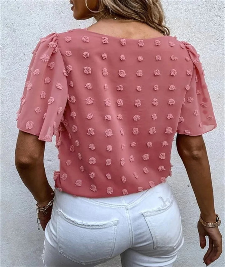 Pink women's floral blouse featuring 3D flower details and short sleeves