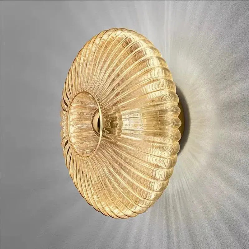 Close up angled view of ribbed glass wall lamp illuminating a wall