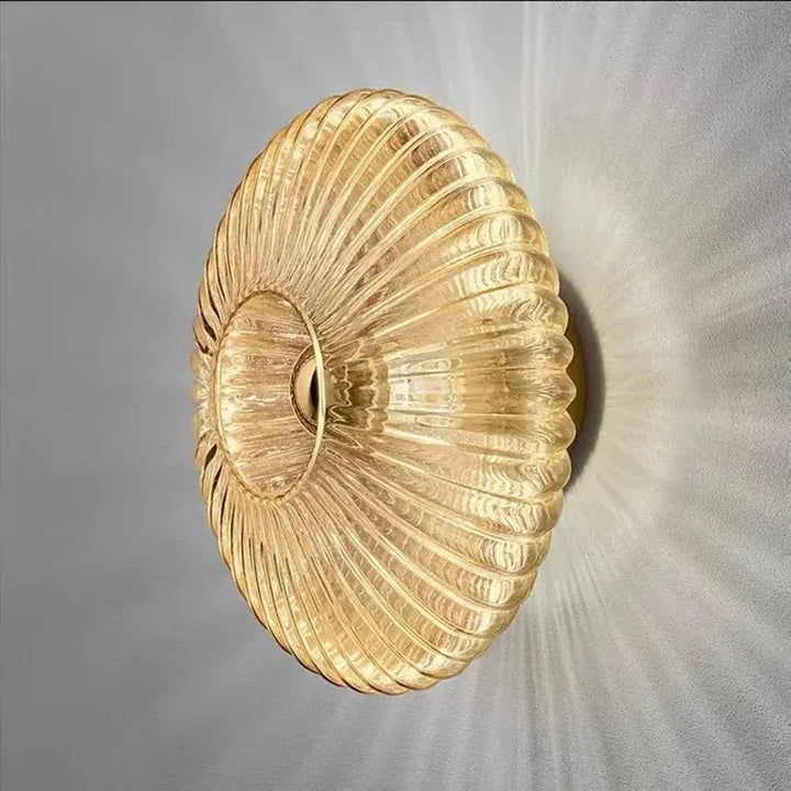 Close up angled view of ribbed glass wall lamp illuminating a wall