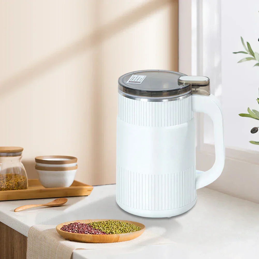 Modern electric spice grinder showing transparent lid and button
