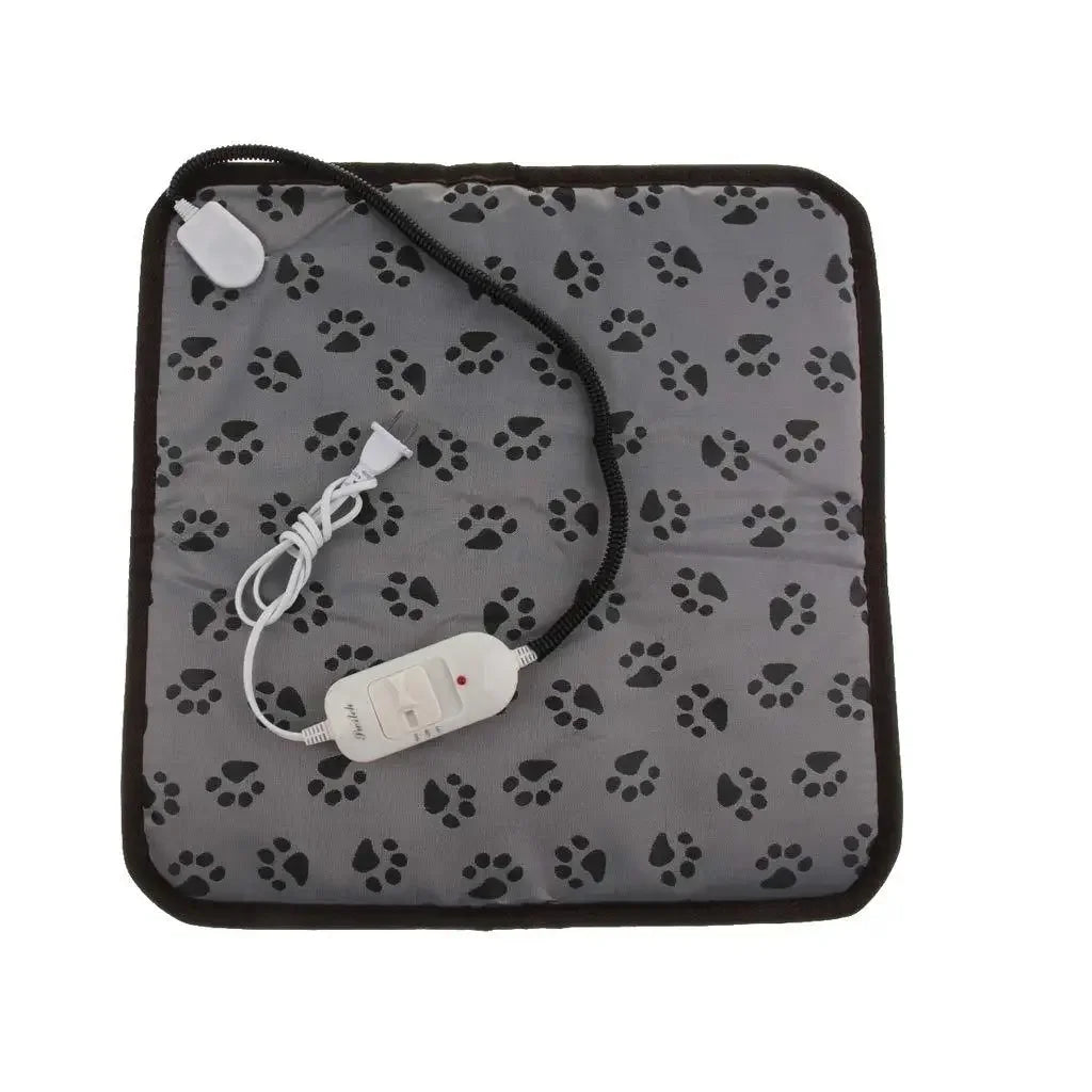 Happy small dog resting comfortably on the electric pet heating mat