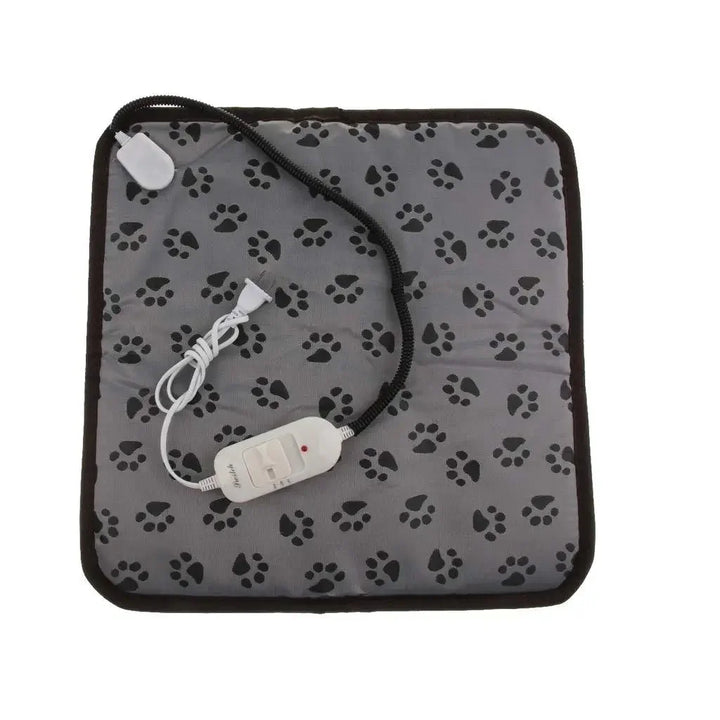 Happy small dog resting comfortably on the electric pet heating mat