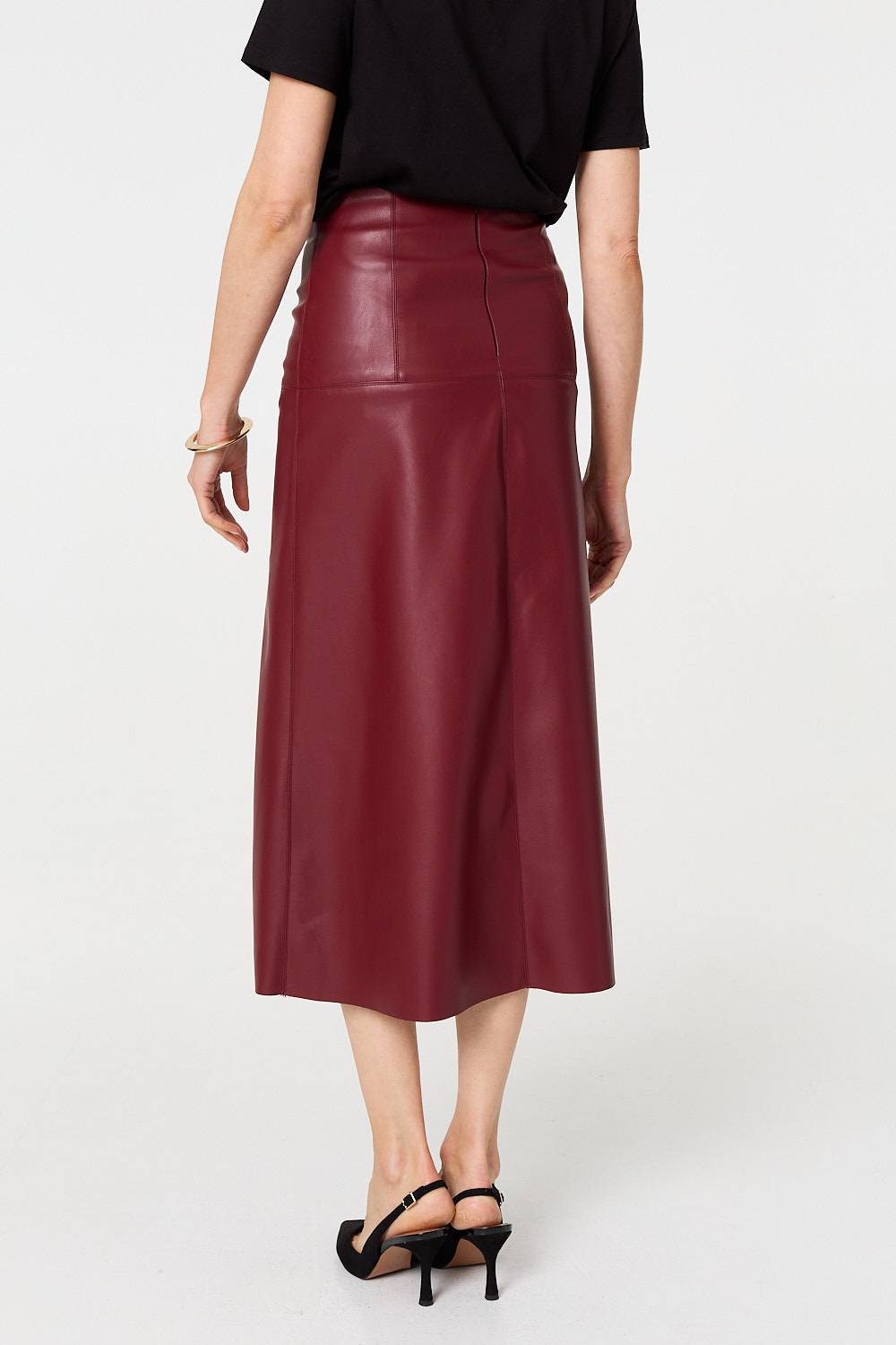 Flat lay of black and brown women's midi skirt collection