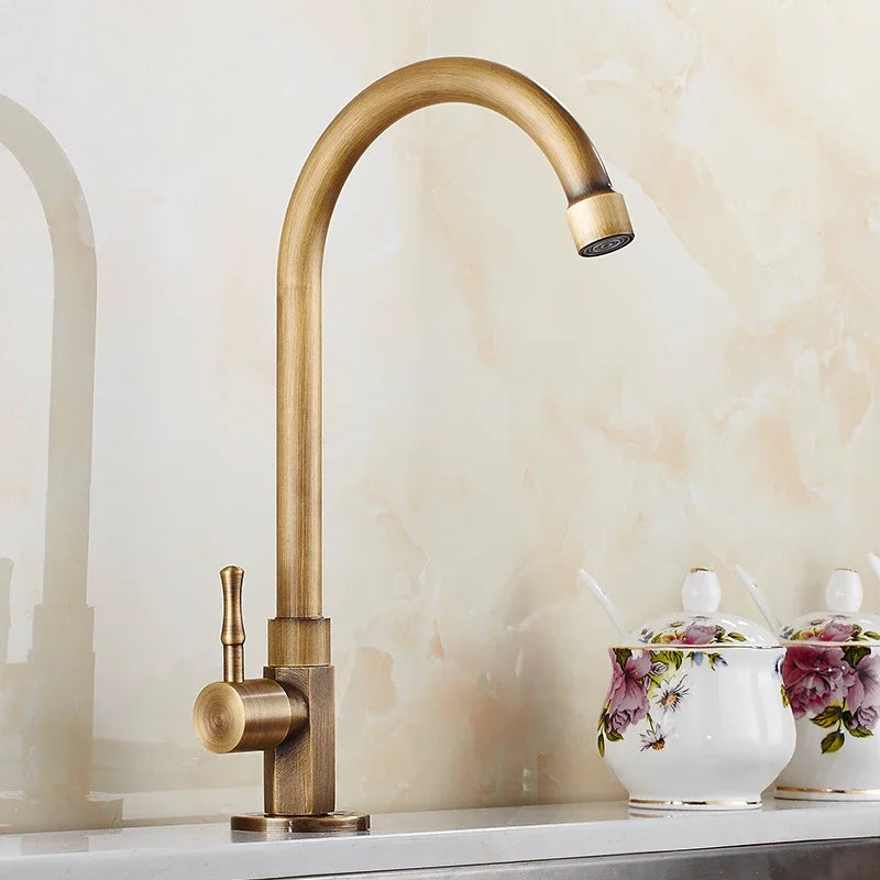 Swan-Neck Antique Brass Kitchen Faucet installed over a countertop