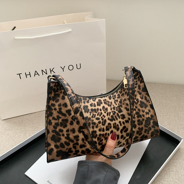 Back exterior pocket detail on chic women's shoulder bag for quick access