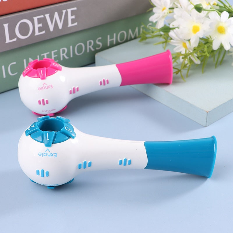 Blue and pink portable respiratory trainer devices displayed on a surface.