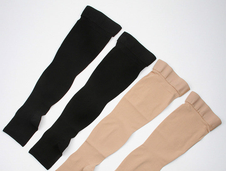 Unisex black thigh high compression stockings for leg support and recovery