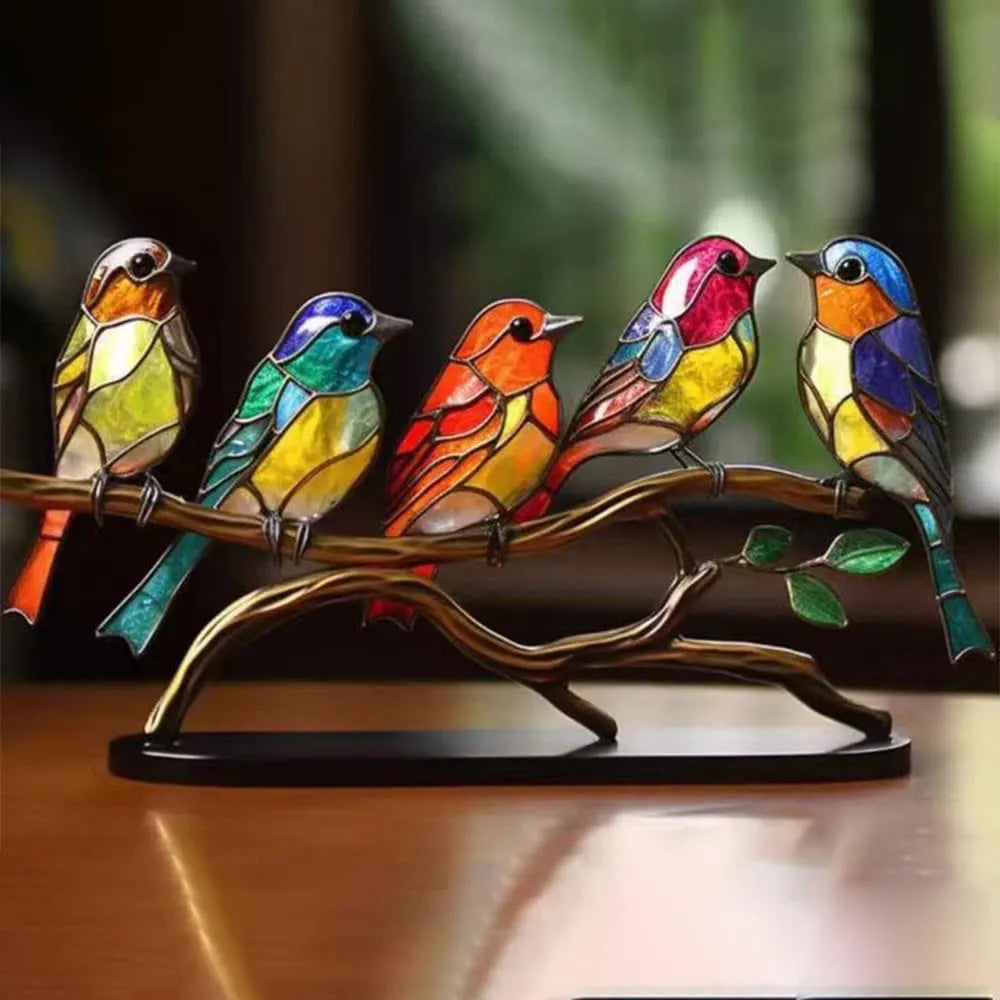 Detailed desk decoration showing colourful birds on a decorative tree branch
