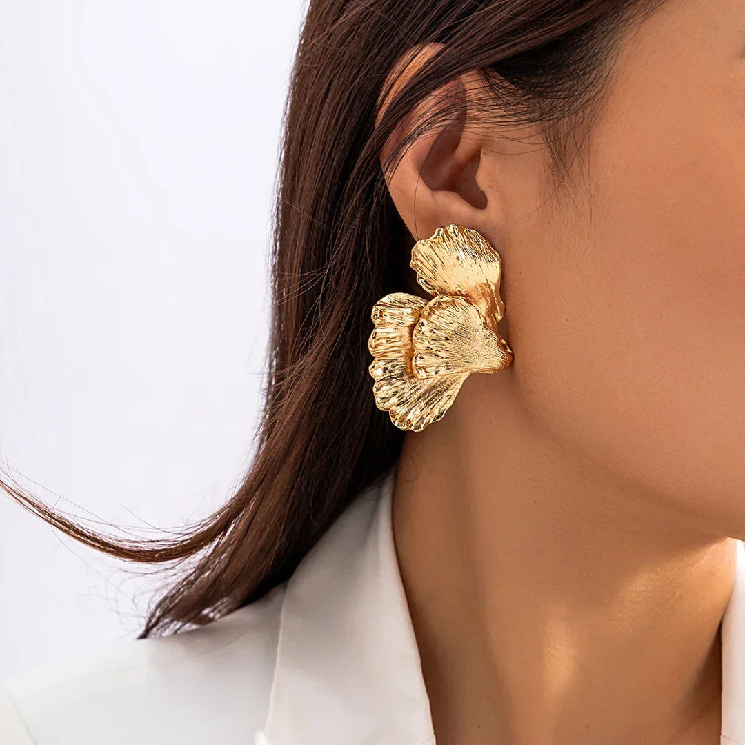 Detailed angle of nature-inspired metal petal earrings