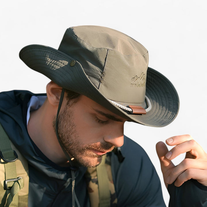 Man wearing army green outdoor bucket hat with side brim buttoned up