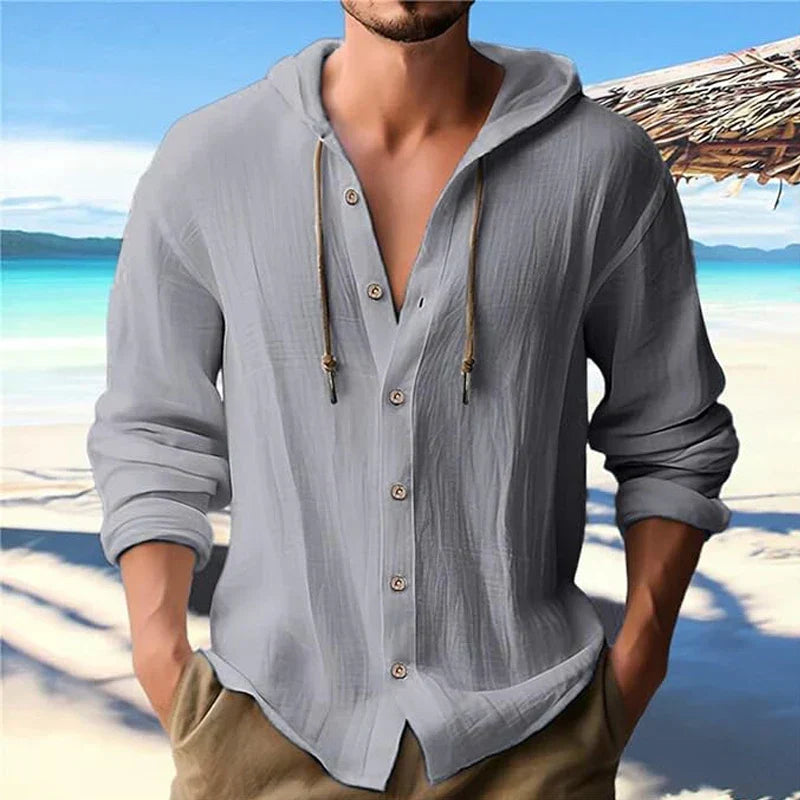 Man wearing a grey long sleeve hooded summer shirt at the beach