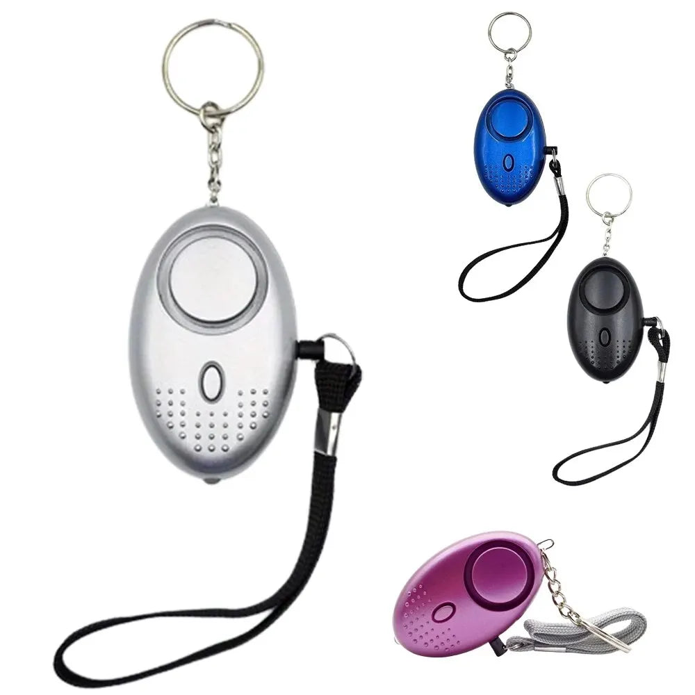 Four personal safety alarms in silver, blue, black, and purple with keychains