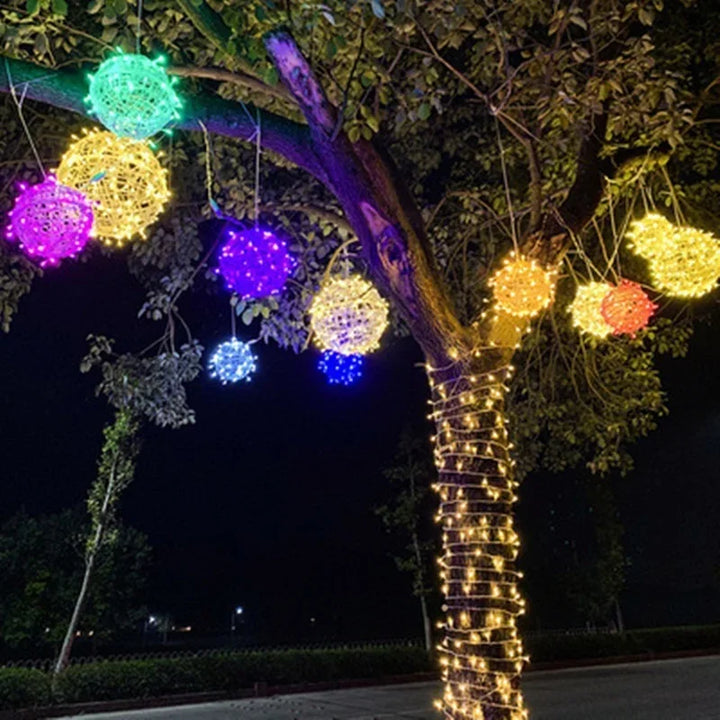 Colorful Sphere rattan string lights glowing in various hues outdoors