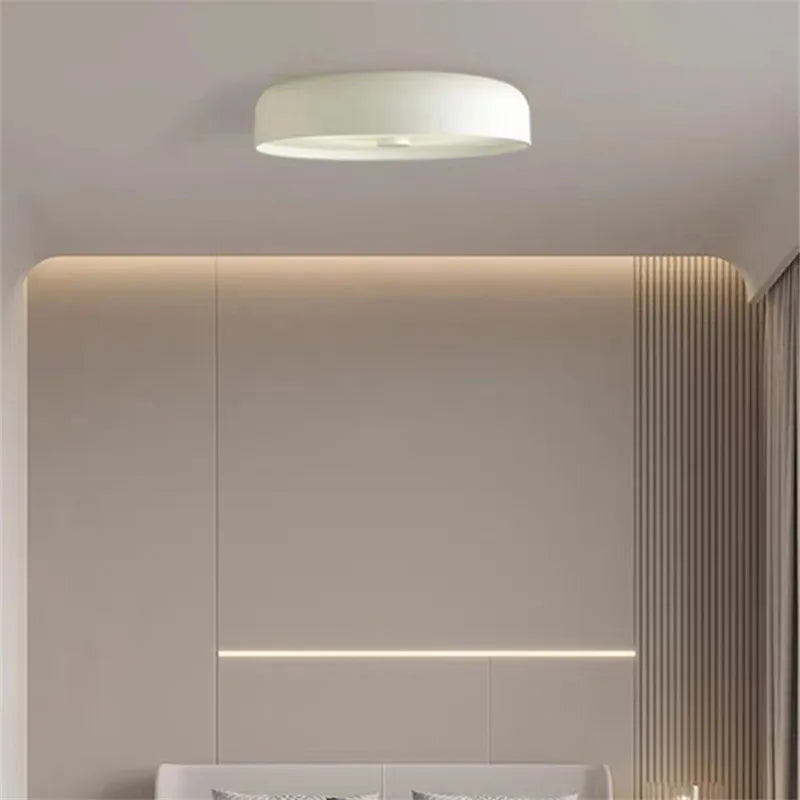 A white minimalist LED ceiling light installed flush against a neutral bedroom ceiling.