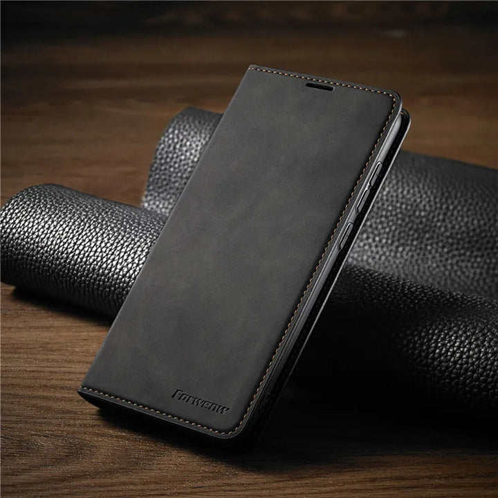 Black magnetic flip phone case resting on a dark textured surface