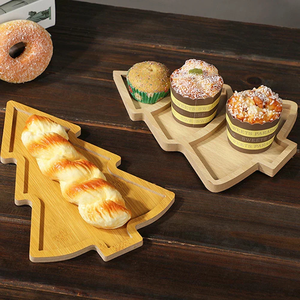 Wooden Christmas tree serving boards loaded with pastries and bread on a rustic table