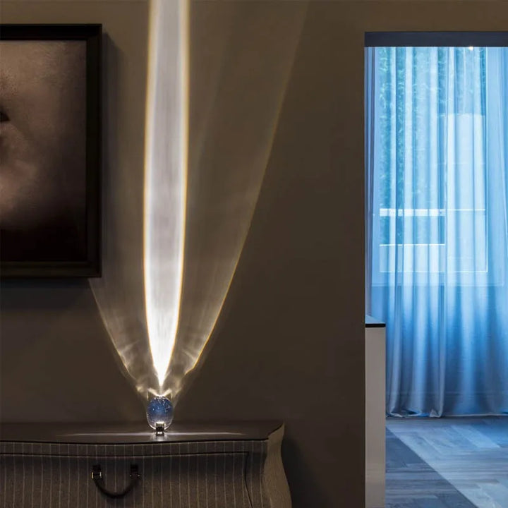 StarGlow crystal lamp casting an upward vertical light beam in a modern room