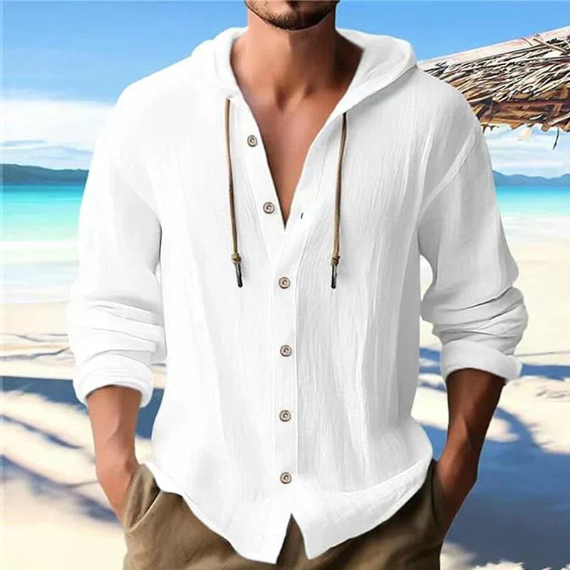 Man wearing a white long sleeve hooded summer shirt at the beach