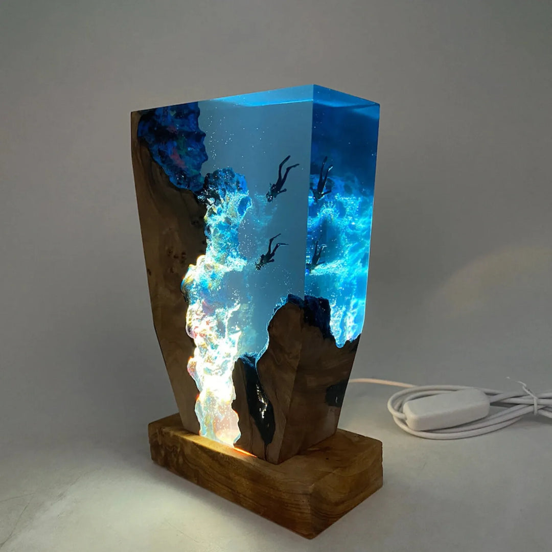 Illuminated ocean resin lamp plugged in with USB cable on a clean surface