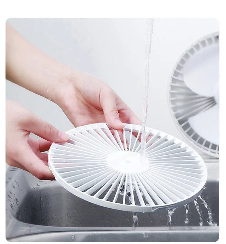 Handheld portable fan showing ergonomic handle and control button