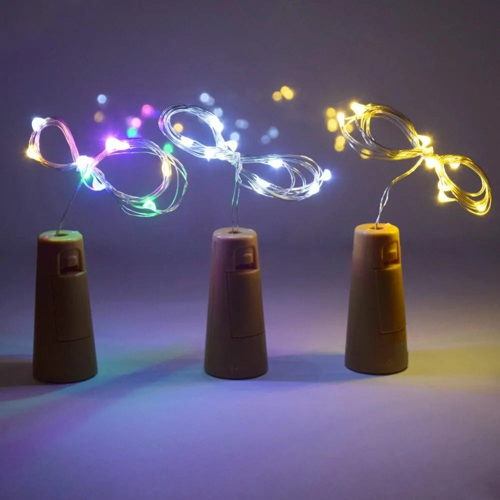 Close-up of LED copper wire fairy lights in warm white and RGB colors inserted into bottle cork bases