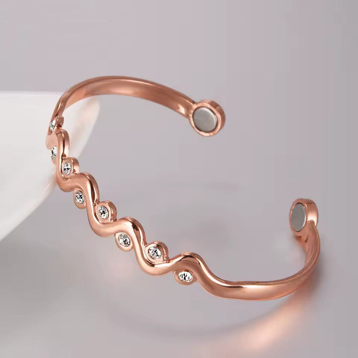 Fashion accessory copper bracelet displayed on a soft neutral surface