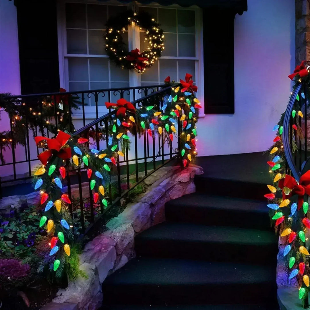 Solar strawberry LED string lights glowing softly on outdoor patio fence