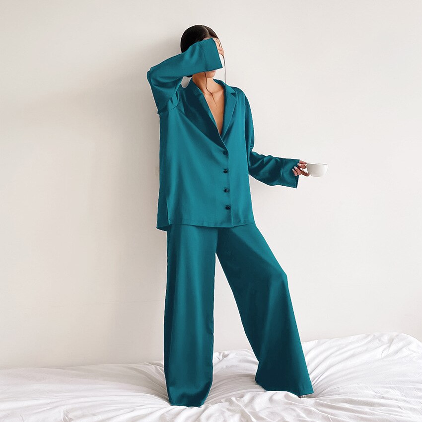 Model showcasing a green satin pyjama set in a bright room