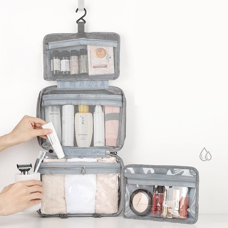 Womens travel makeup pouch hanging open on a bathroom door hook