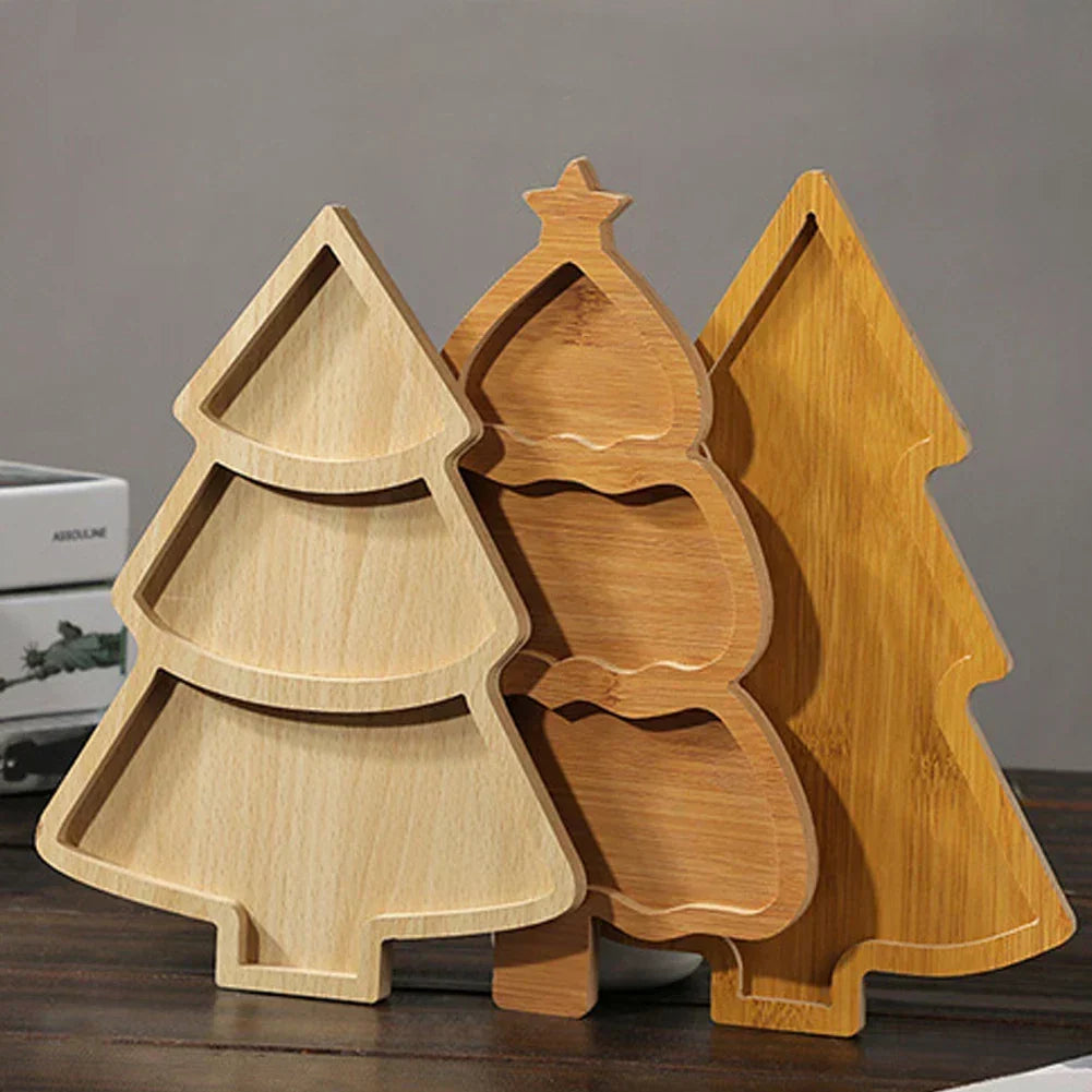 Three different wooden Christmas tree serving boards displayed upright together