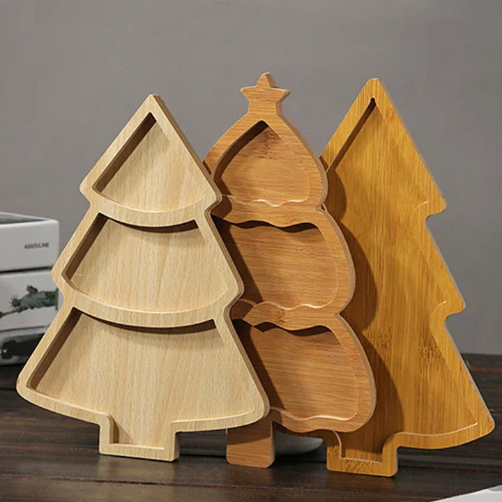 Three different wooden Christmas tree serving boards displayed upright together