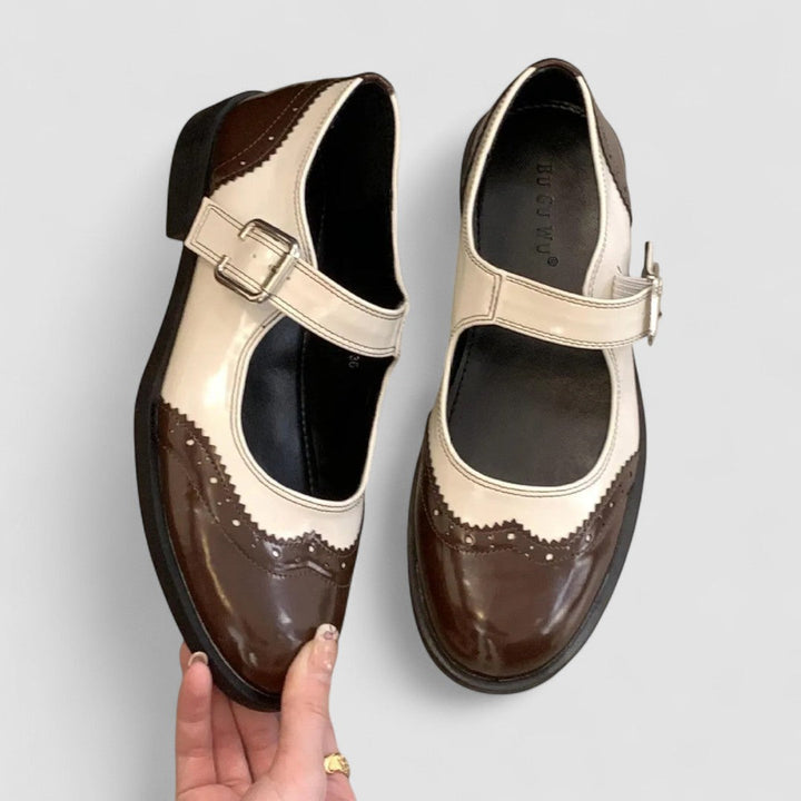Stylish brown leather Mary Jane flats for women, showcasing a rounded toe and buckle.