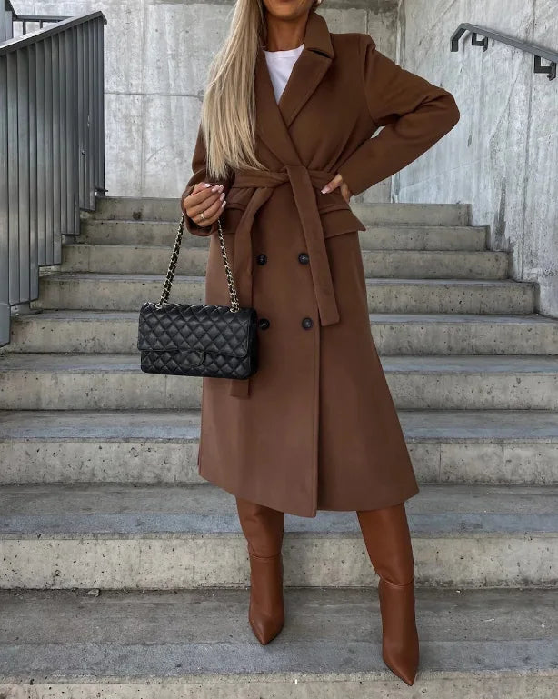 Woman wearing coffee brown long lapel coat paired with tall boots