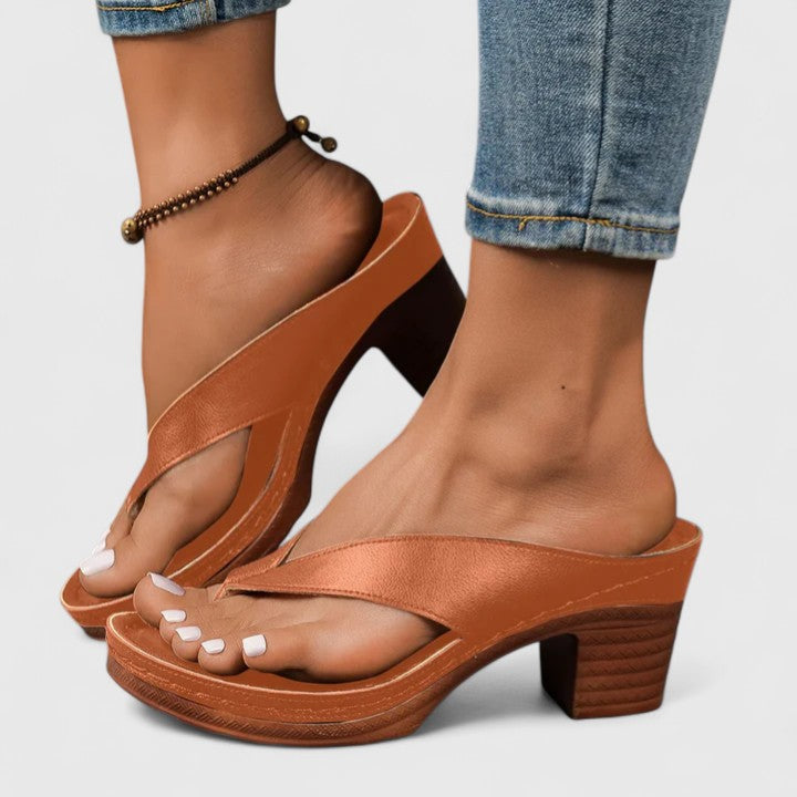 Side profile of brown Talia block heel thong sandals worn with jeans
