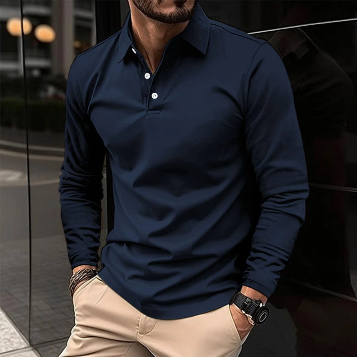 Man wearing navy blue long-sleeved polo shirt with khaki trousers