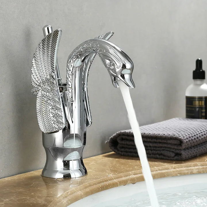 Close-up view of a chrome swan faucet with running water