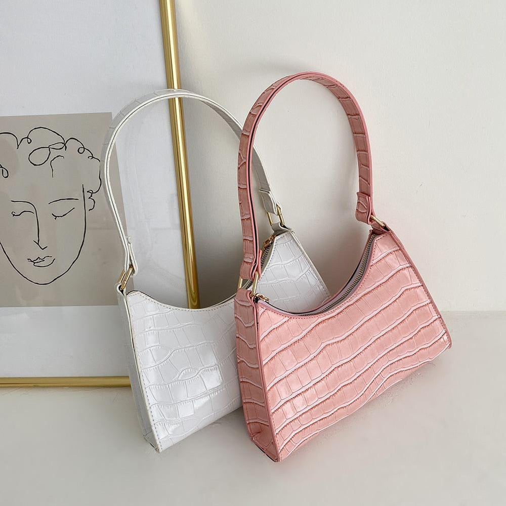 White and pink textured women's shoulder handbags displayed together