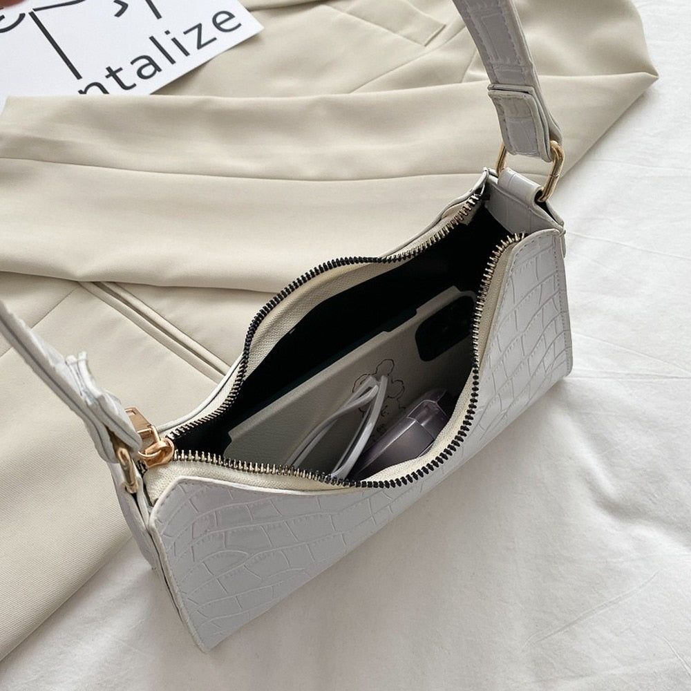 Durable metal strap rings and reinforced stitching on elegant women's handbag