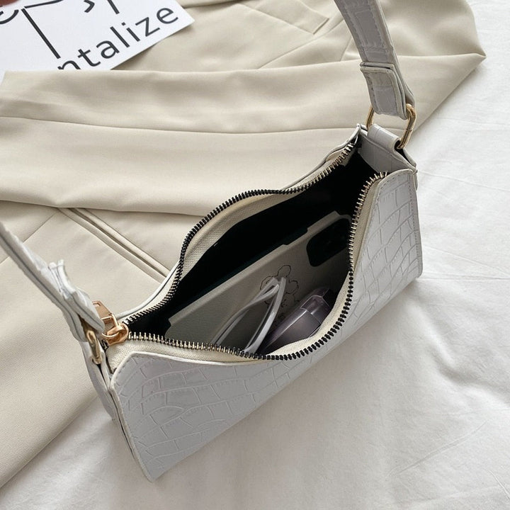 Durable metal strap rings and reinforced stitching on elegant women's handbag
