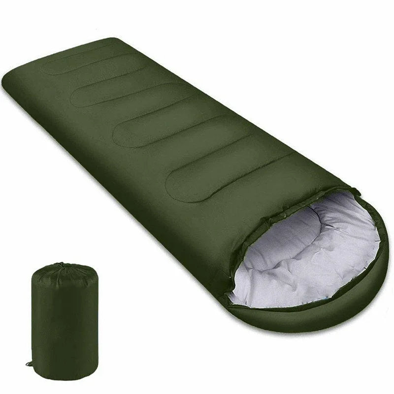 Green ultralight sleeping bag rolled out with storage sack next to it
