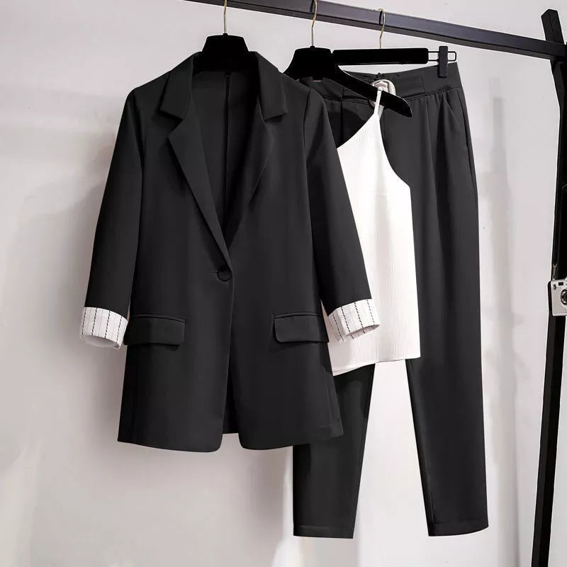 Black women's three-piece blazer suit set with matching trousers and top