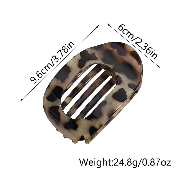 Product dimension graphic showing the flat oval hair claw clip measuring 9.6 cm by 6 cm and weighing 24.8 g