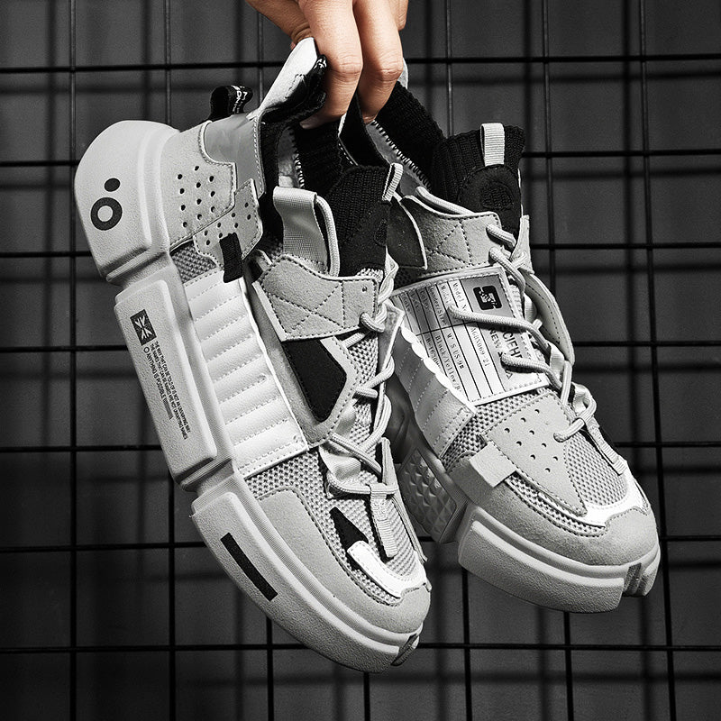 Light grey men's streetwear sneakers held up against grid background