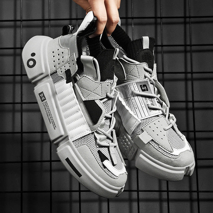 Light grey men's streetwear sneakers held up against grid background