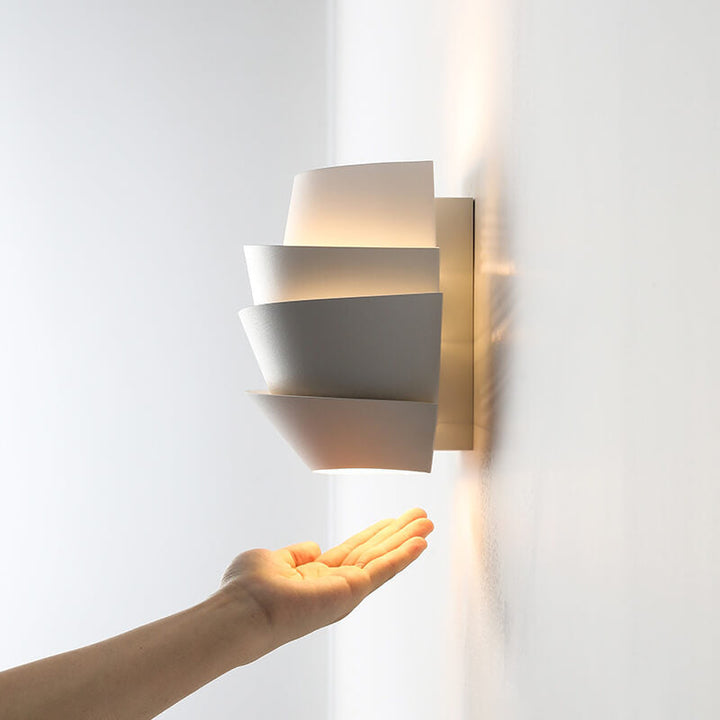 Warm glowing modern wall lamp creating a cozy ambiance in a bedroom