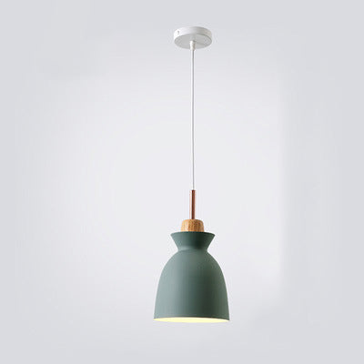 Green bell shaped Nordic metal pendant lamp hanging against a clean backdrop