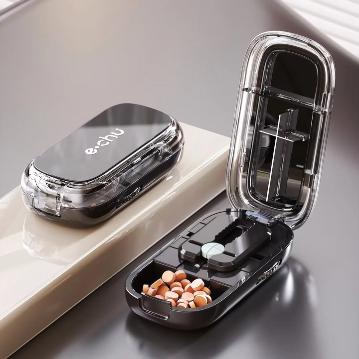Compact travel pill box and storage container open to show internal medication compartments.